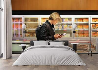 Man choosing frozen food from a supermarket freezer	 Wall mural