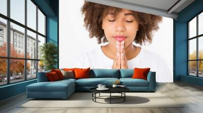 Praying young afro american girl. African woman in summer shirt isolated on white background. Copy space. Mock up. Make a wish Wall mural