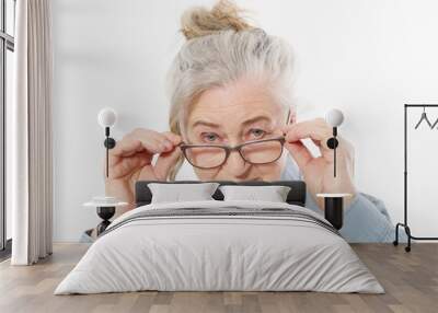 Surprised and shock Senior woman with wrinkle face and eye care glasses isolated on white background. Mature healthy lady. Copy space. Seniors lifestyle and old people happy concept. Wall mural