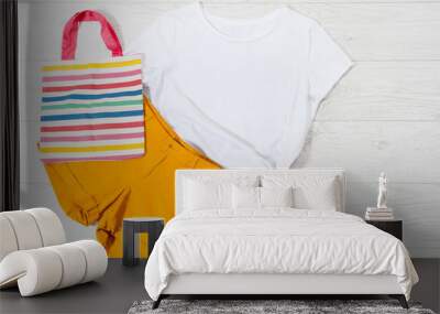 White closeup t shirt mock up flat lay on white wooden background. Top view and copy space. Mockup summer t-shirt and summertime. Template blank shirt. Wall mural