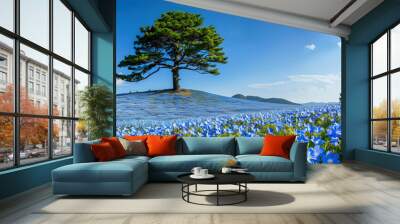 A pine tree in an endless sea of blue flowers Wall mural