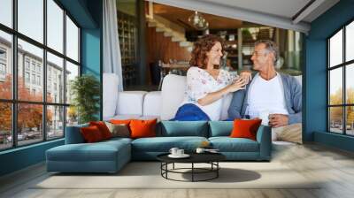 And then I said.... A happy mature couple enjoying a cup of coffee together on the sofa at home. Wall mural