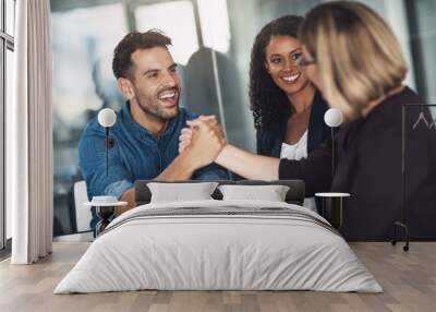 Strong partners make a strong business relationship. Shot of a businesswoman and businessman shaking hands during a meeting in a modern office. Wall mural