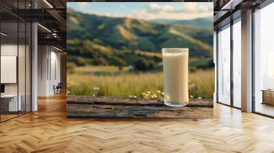 A refreshing glass of milk placed on a wooden table with a natural background. The image highlights the purity and health benefits of milk, making it suitable for dairy advertisements. Wall mural