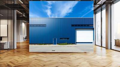 Exterior a blue industrial warehouse dock station exterior with blue metal cladding and white garage door. Commercial storehouse building, business unit, cargo factory, distribution, logistic business Wall mural