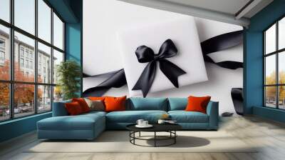 Elegant White Gift Box with Black Ribbon on White Background - Perfect for Celebrations and Special Occasions Wall mural