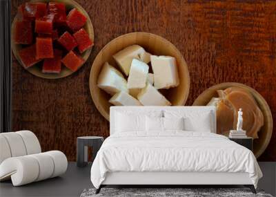 Dulce de leche, guava and white cheese on wooden table - Brazilian desserts. Top view Wall mural