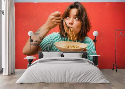 young woman eating pasta cute girl eating spaghetti having fun delicious food photography Wall mural