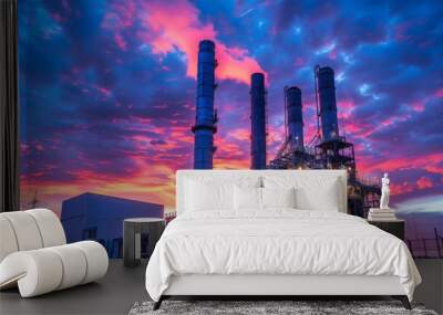 A dramatic evening sky behind the imposing structure of a gas turbine electrical power plant, symbolizing industrial power Wall mural