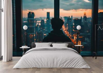 A person looking out of a window from a high-rise apartment, watching the bustling city below but feeling disconnected and lonely. Wall mural