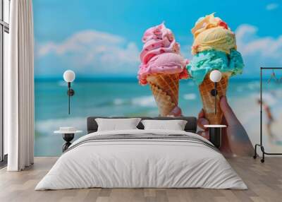 Bright, colorful ice cream cones in hands with a beach background Wall mural