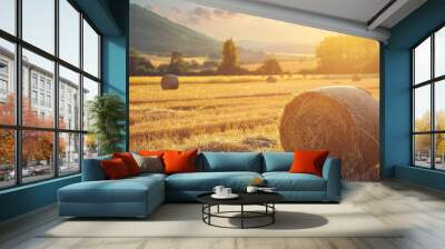 Farmers baling hay in a golden field during harvest season Wall mural