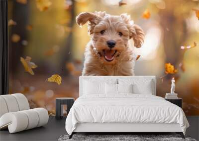 Puppy running through autumn leaves with a joyful expression Wall mural