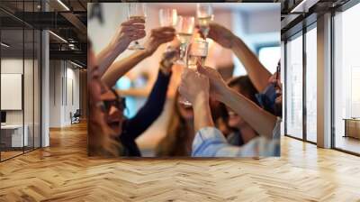 Startup team celebrating their first sale, clinking glasses in an office Wall mural