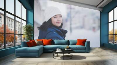  Asian girl enjoying snowfall Wall mural