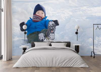 Asian child sliding on snow Wall mural