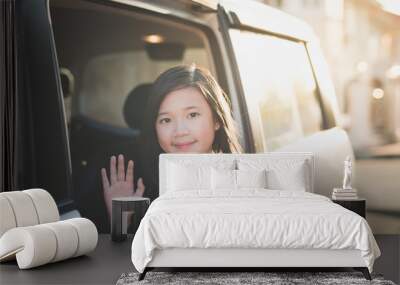 Asian girl in student uniform going to school by car and  waving goodbye Wall mural