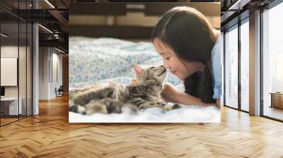 Beautiful asian girl kissing american shorthair cat Wall mural