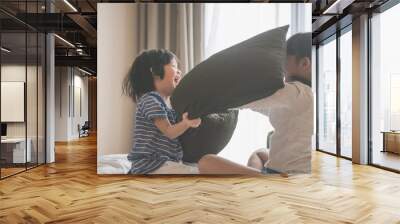 Happy Asian child ren having Pillow Fight in Hotel Room Wall mural