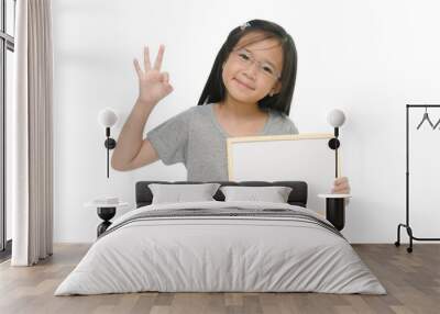 Little Asian girl holding empty whiteboard Wall mural