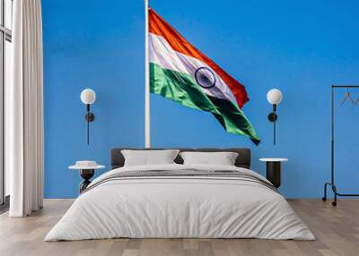 Indian National Flag , flying high in the sky on a clear blue background. Wall mural