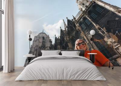 Woman stands on the background of St. Stephen's Cathedral in Vienna, Austria Wall mural