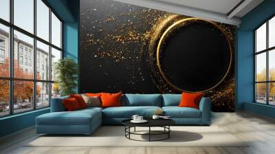 A circular golden sparkly element in the center of the image, with a dark background and speckles of light in various shades of gold. Wall mural