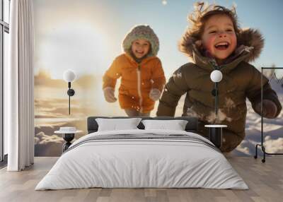 Two happy little kids running after each other Wall mural