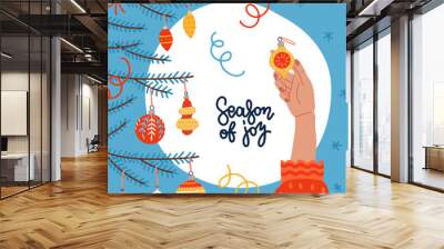 Merry Christmas and Happy New Year Greeting card. Young women hand decorating Christmas tree with elegant glass bauble. Winter holidays banner with Fir branches. Lettering quote Season of joy. Wall mural