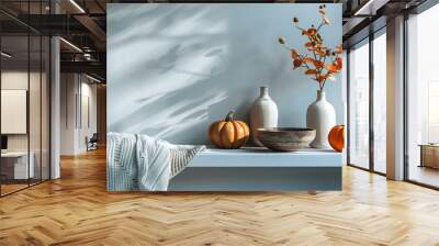 Home interior with pastel grey blue wall and a small floating shelf featuring autumn decor elements. Seasonal design with copy space. Wall mural