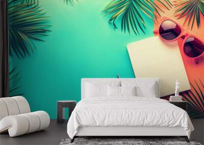 Notepad paper, glasses and pen placed on a stylish background decorated with palm leaves. Wall mural