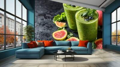 Fresh green smoothie with fruits and mint on dark background Wall mural