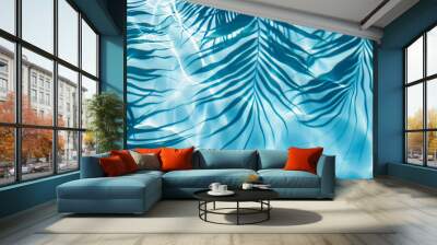 A blue palm leaves reflected in the water. Tropical leaf shadow on water surface. Shadow of palm on blue water. Beautiful abstract background Wall mural