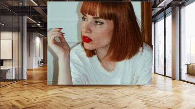 Closeup shot of a Caucasian woman against the white background Wall mural