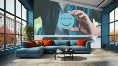 Hand holding blue paper cut happy smile face, positive thinking, mental health assessment , world mental health day concept	 Wall mural