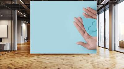 Woman hand holding smile water drop paper cut, world water day, clean water and sanitation, hand sanitizer and hygiene, washing hands, CSR, save water, clean renewable energy concept Wall mural