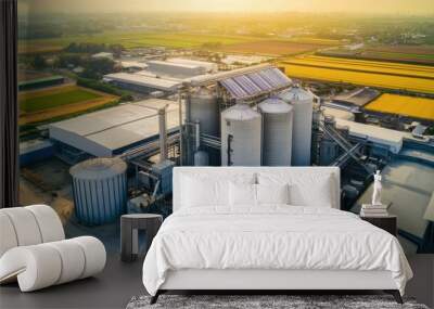 Aerial view of modern agricultural feed production facility featuring industrial silos and sustainable solar panel installations showcasing integration of renewable energy in manufacturing operations Wall mural