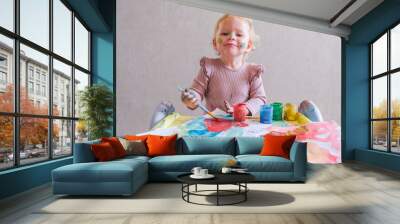 Female toddler drawing at table Wall mural