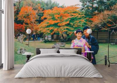 Asian senior couple dressing kimono posing with autumn tree and japanese garden during autumn season. Kyoto, Japan Wall mural