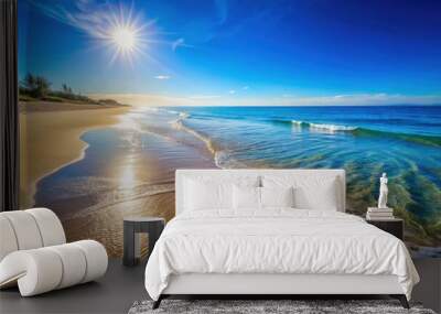 Sunlit beach scene with calm waters, sandy shoreline, and clear blue sky, serene, tranquil, peaceful, relaxation, seaside, coast Wall mural