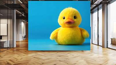 Yellow plush duck toy isolated on blue background, plush, duck, toy, yellow, isolated, blue, background, animal, cute, soft Wall mural