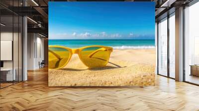 Yellow sunglasses on a sandy beach with a view of the sea and clear blue sky, yellow, sunglasses, sandy beach, sea Wall mural