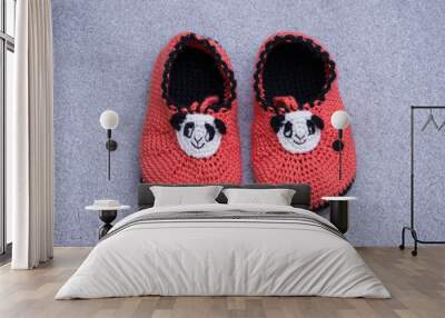 Children's knitted shoes with non-slip soles with a panda motif. Wall mural