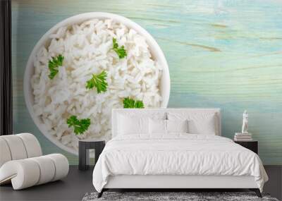 A photo of a bowl of cooked white long rice, shot from the top on a teal blue background with copy space Wall mural