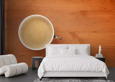 An overhead photo of coffee in a vintage cup, shot from the top on a dark rustic wooden background with copy space Wall mural