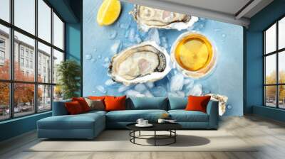 Fresh raw oysters, overhead shot on ice with a glass of white wine and lemon slices Wall mural