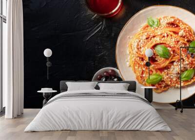 Italian pasta panorama with a place for text. Spaghetti with tomato sauce and basil, olives, wine, ravioli etc, overhead flatlay shot on a dark background with copyspace Wall mural