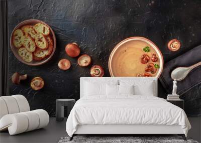 Mushroom soup with various mushrooms and toasted bread, overhead flat lay shot on a black slate background with a place for text Wall mural