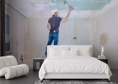 Worker make repairs in new apartment. Man plaster walls and ceilings. High quality photo Wall mural