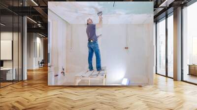 Worker make repairs in new apartment. Man plaster walls and ceilings. High quality photo Wall mural